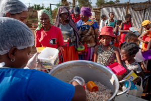 community coming together for food at the friday night feeding station with the winnie mabaso foundation