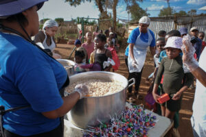 helpers giving out food at the winnie mabaso feeding station