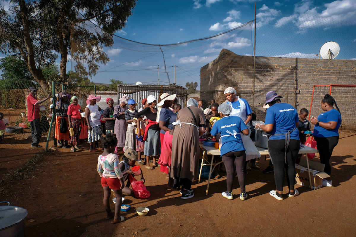 community queing for food at the winnie mabaso foundation friday night feeding station
