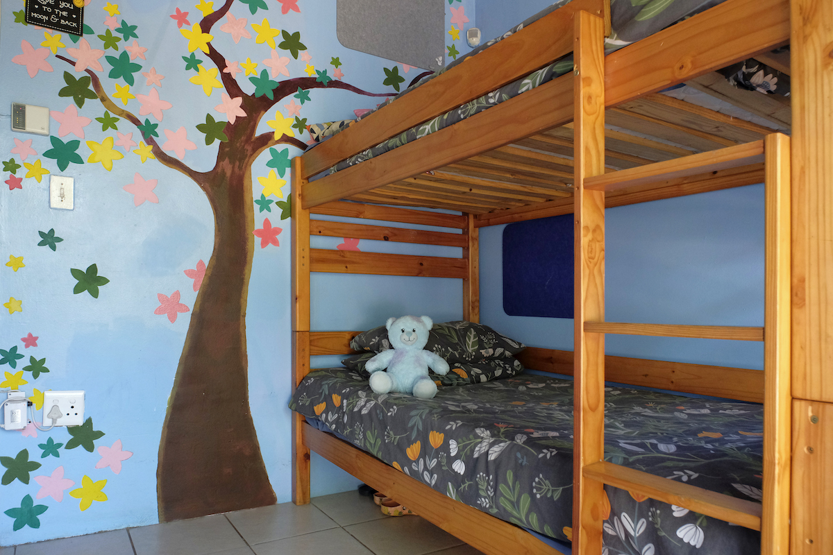 bedroom inside the winnie mabaso foundation ilamula house with tree on wall